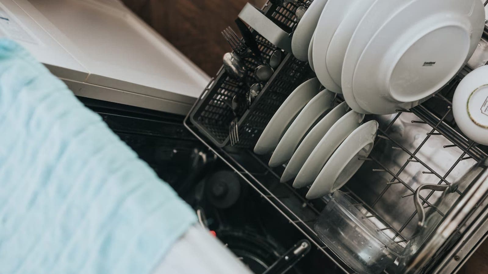 Open dishwasher with clean dishes inside