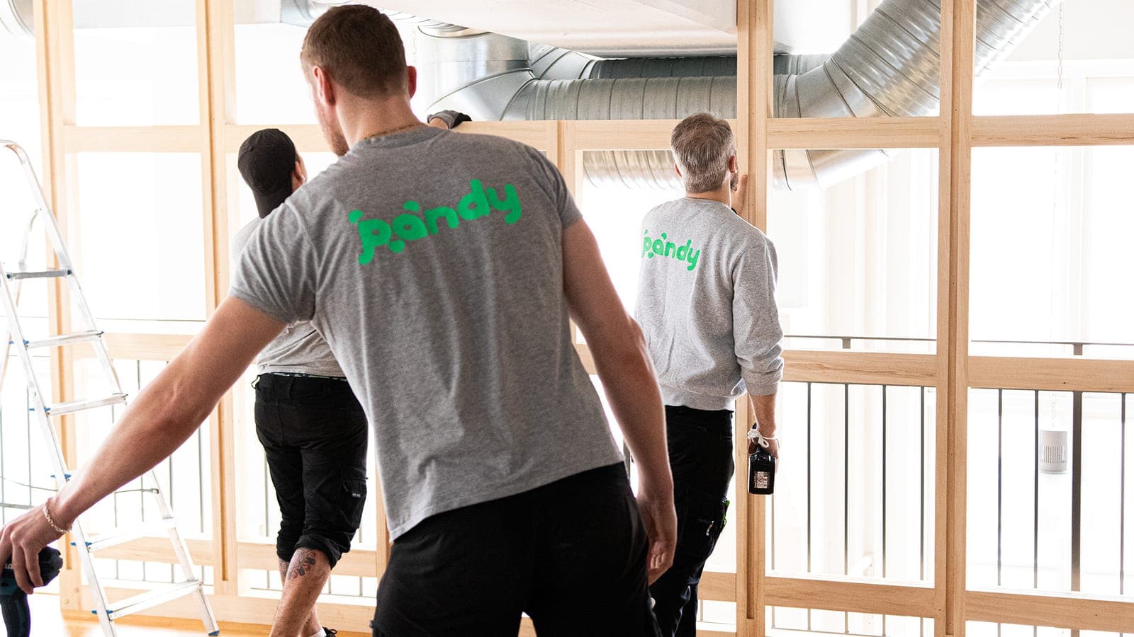 Pandy movers dismantling furniture in an office
