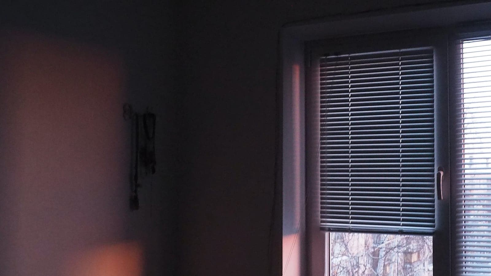 Blind half pulled down at dusk