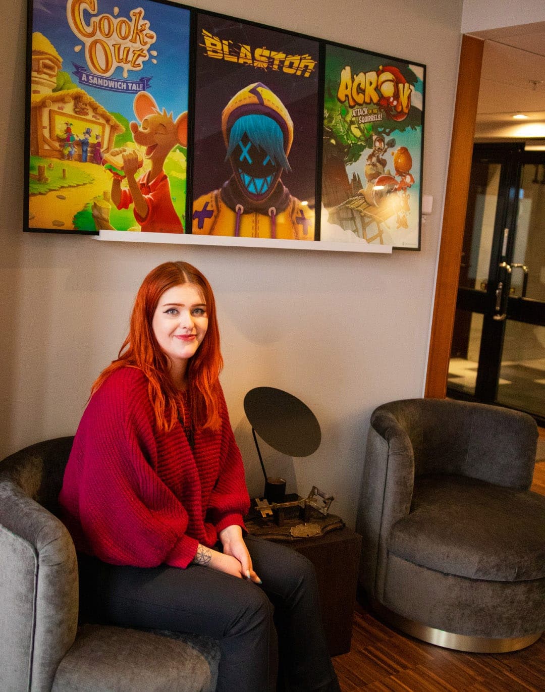 Happy young woman in the entrance of the Resolution Games office