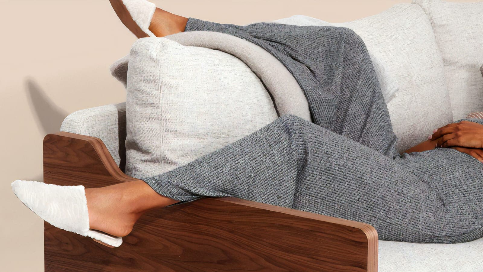 Person lying on a white sofa