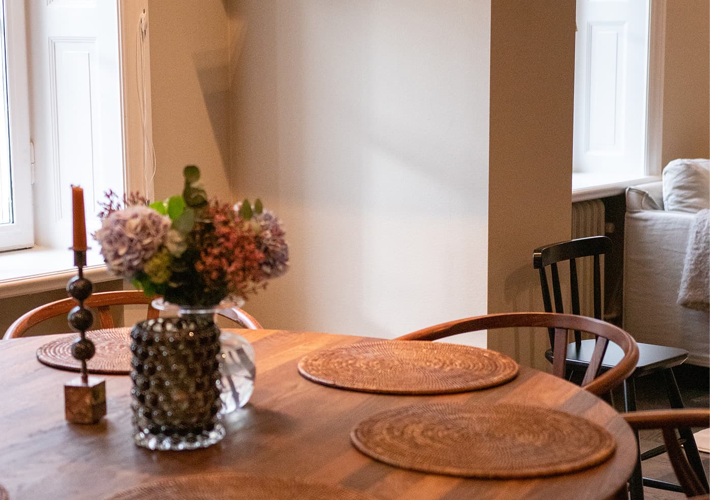 A set dining table with flowers in a bright home