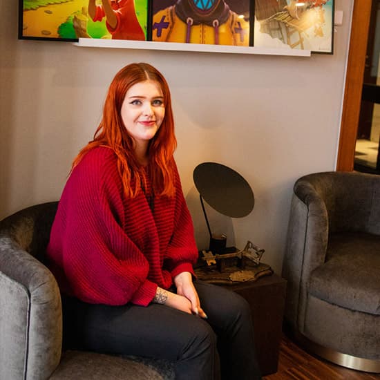 Happy young woman in the entrance of Resolution Games' office