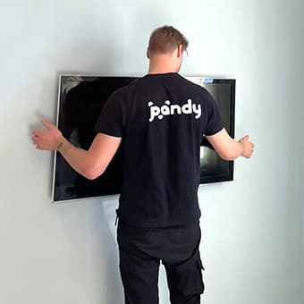 Pandy handyman mounting a TV on the wall